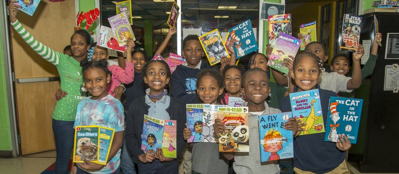 Kids with books from Cleveland Kids' Book Bank