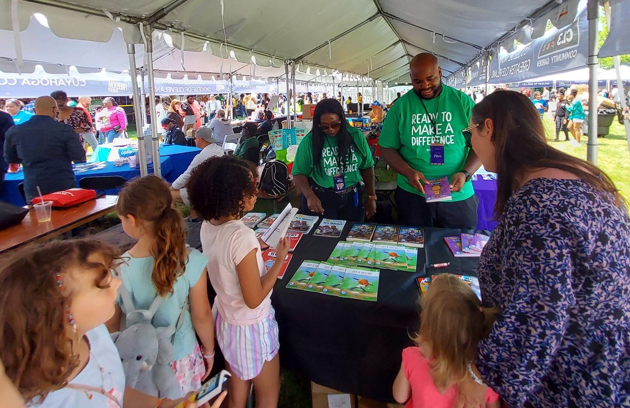 children lined up in front a table covered with books